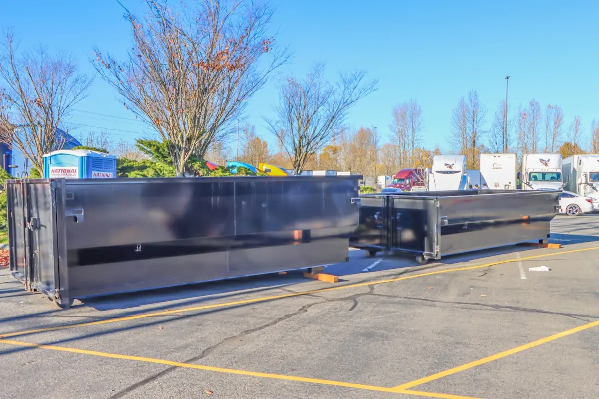 Professional dumpster rental service with roll-off container on residential driveway in Rio Linda